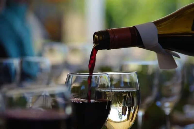 Small group sampling wines on the terrace of a West Kelowna winery overlooking Okanagan Lake on a full-day wine tour